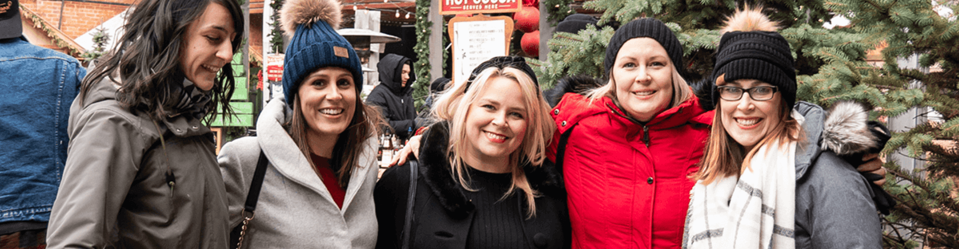 A guide leading a walking tour group along a red brick lane in Toronto's Distillery District