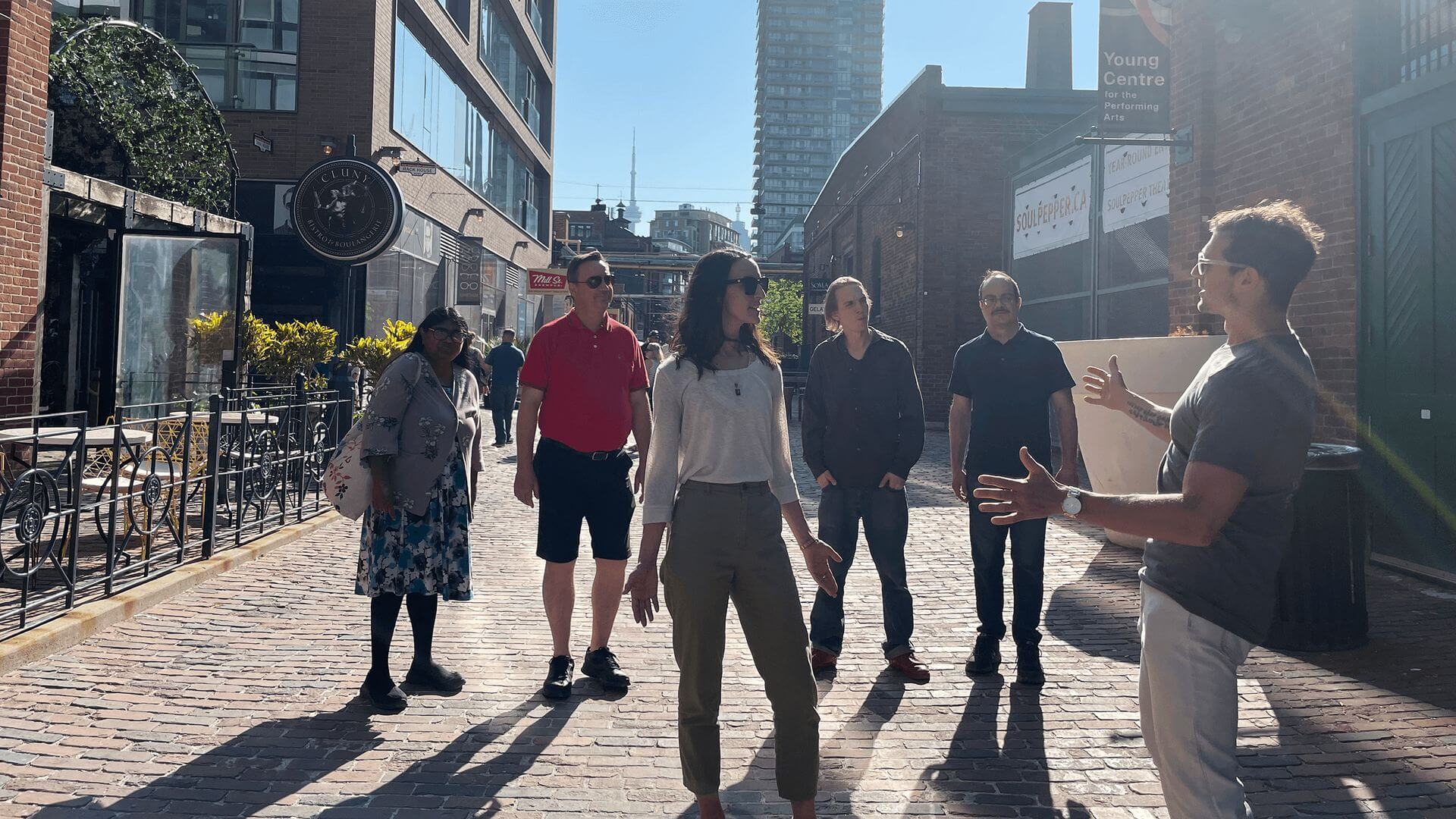 A corporate group on a walking tour in Toronto's Distillery District